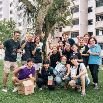 Corporate volunteers distributing Bags of Love to beneficiaries in need, fostering community support, kindness, and social responsibility.