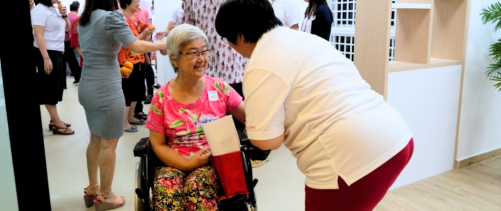 Employees engaging in interaction with eldery during a CSR team building event
