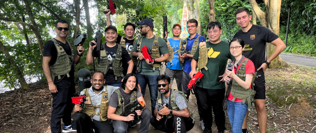 a dynamic indoor laser tag arena in singapore, filled with vibrant colored lights and corporate teams engaged in an energetic match, showcasing the excitement and collaboration of corporate events. Budget-Friendly Team Building Ideas