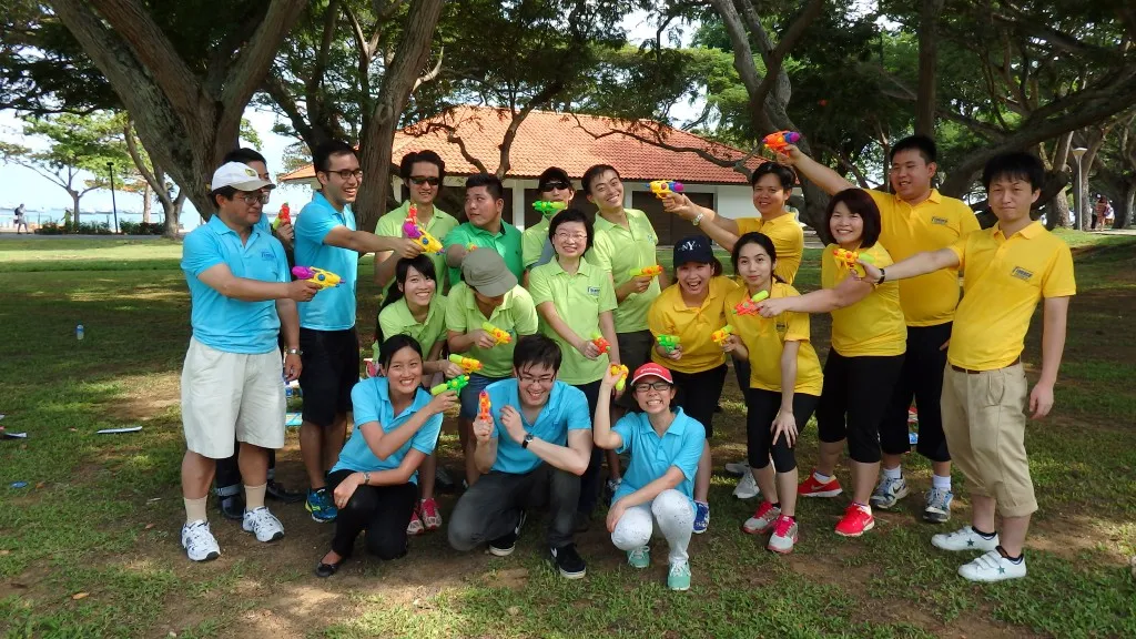 Celebration of team building benefits with employees enjoying outdoor activities