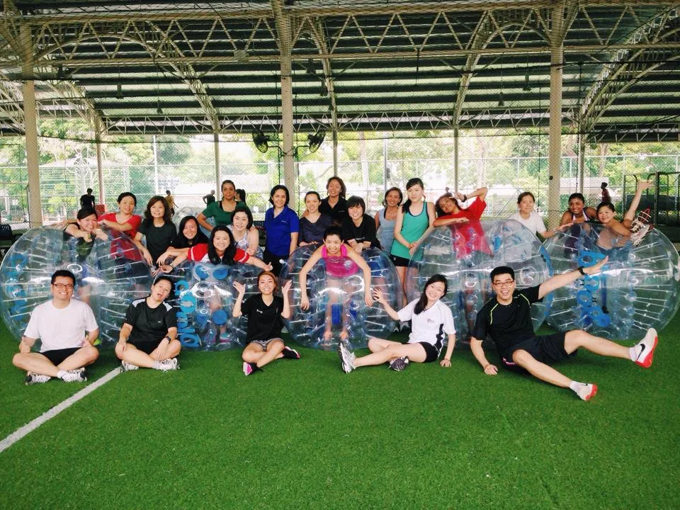 Customized outdoor team building event in Singapore with employees collaborating